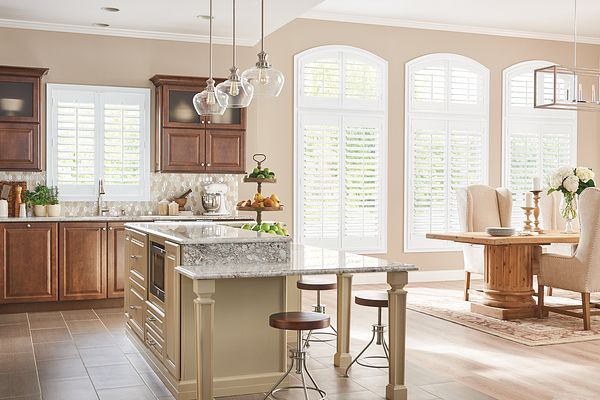 Wood composite shutters span dining room and kitchen let in morning light in Scottsdale AZ and Boerne TX