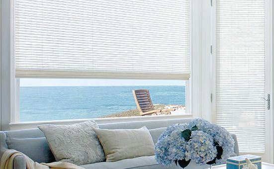 Custom woven wooden shades diffuse coastal light from Blinds by Design
