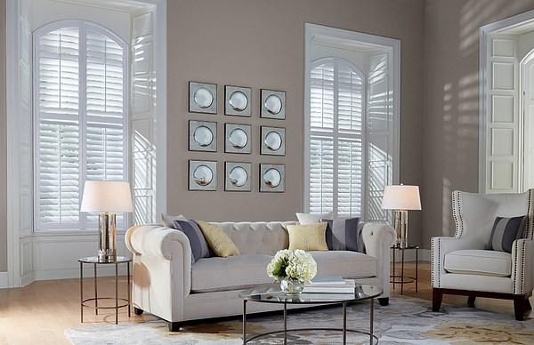Modern white shutters behind a couch